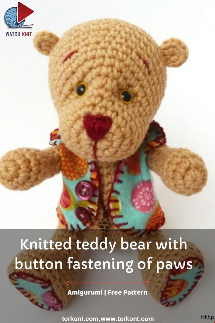 Knitted teddy bear with button fastening of paws